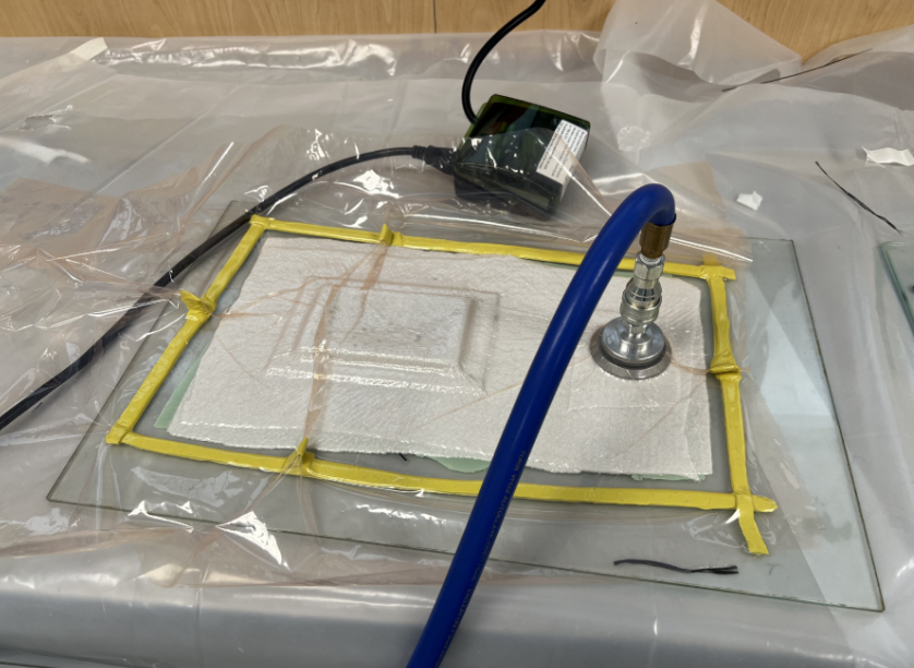 Wet-layup composite during vacuuming